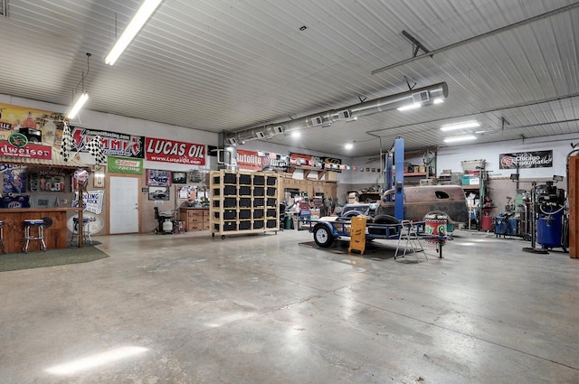 garage featuring a workshop area and metal wall