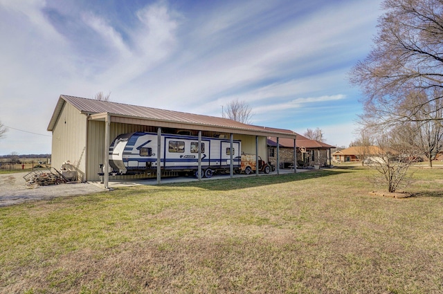 back of property featuring metal roof and a lawn