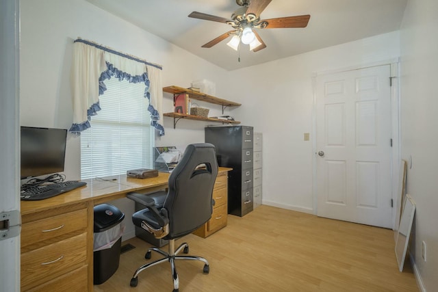 office featuring a ceiling fan, light wood-style flooring, and baseboards