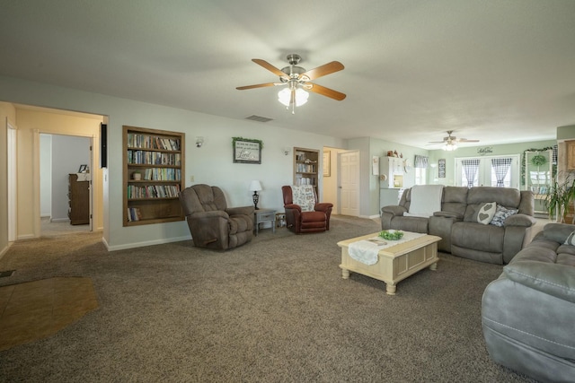 carpeted living area featuring baseboards, visible vents, and ceiling fan