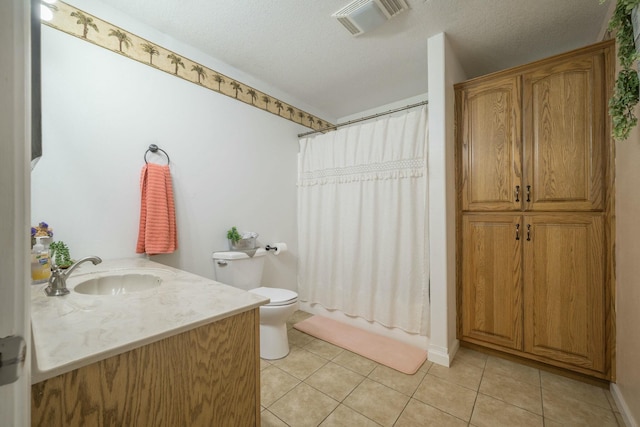 bathroom with toilet, visible vents, a textured ceiling, and tile patterned floors