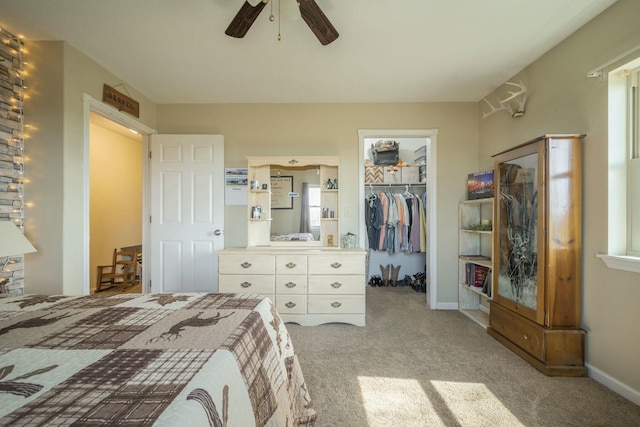 bedroom featuring baseboards, ceiling fan, a spacious closet, carpet flooring, and a closet