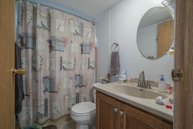 bathroom featuring curtained shower, vanity, and toilet