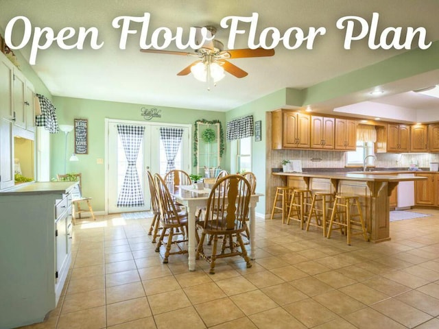 dining area with a ceiling fan, french doors, baseboards, and light tile patterned floors