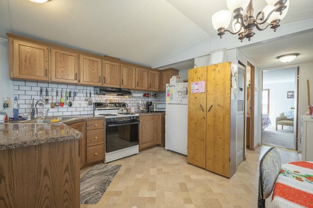 kitchen with extractor fan, electric range, a sink, freestanding refrigerator, and brown cabinetry