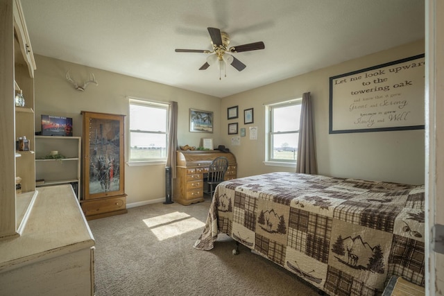 carpeted bedroom featuring ceiling fan and baseboards