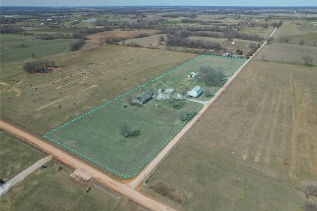 birds eye view of property with a rural view