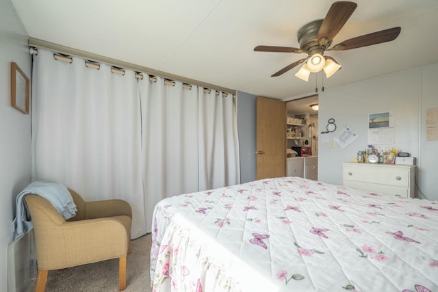 carpeted bedroom featuring washing machine and dryer and ceiling fan