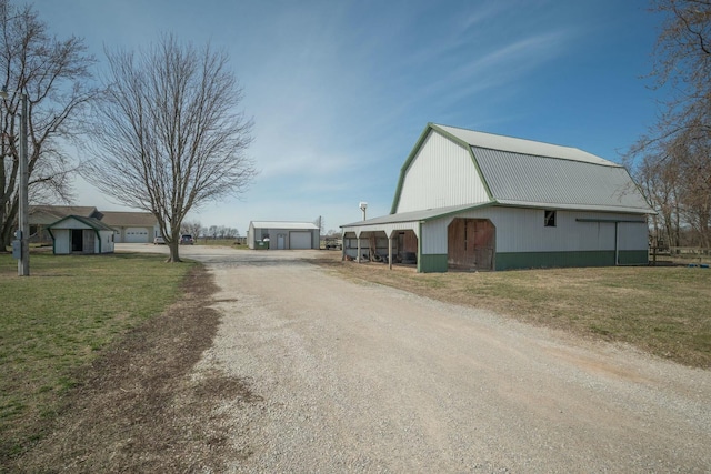 view of street featuring a barn and driveway