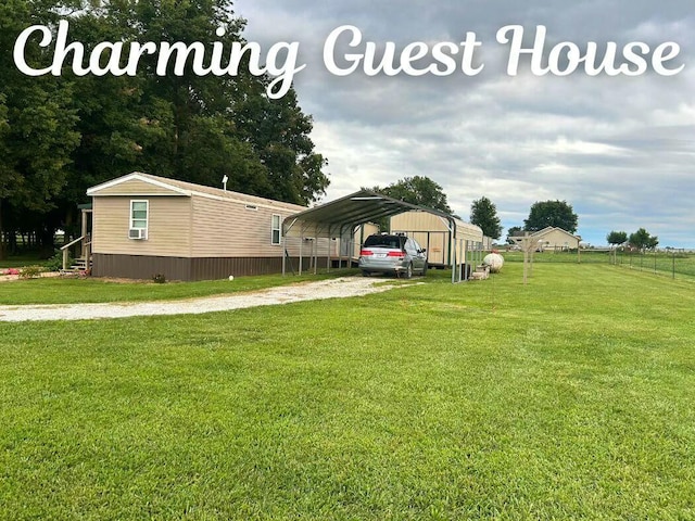 view of yard with driveway, cooling unit, and a detached carport