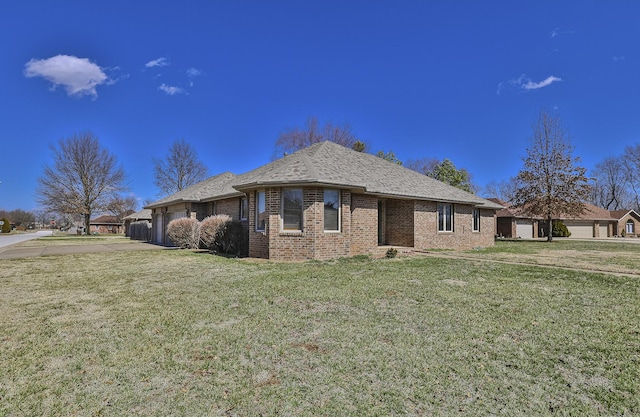 view of front of property with brick siding and a front lawn