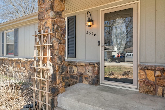 doorway to property featuring stone siding