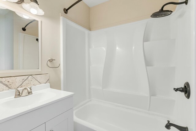 bathroom featuring washtub / shower combination and vanity