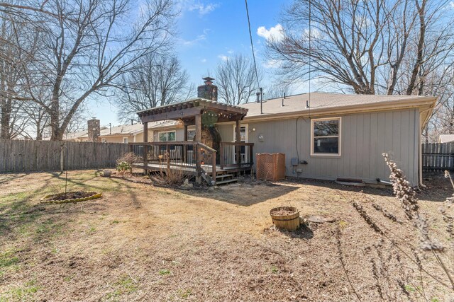 back of property featuring a chimney, an outdoor fire pit, a pergola, a fenced backyard, and a wooden deck
