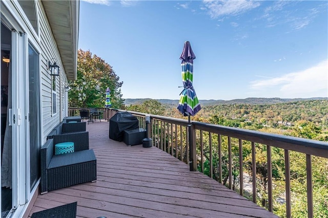 wooden terrace featuring a mountain view and area for grilling