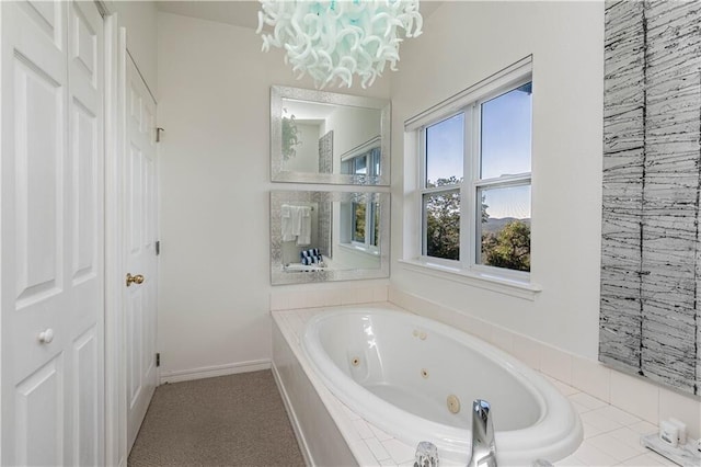 bathroom with a whirlpool tub and baseboards