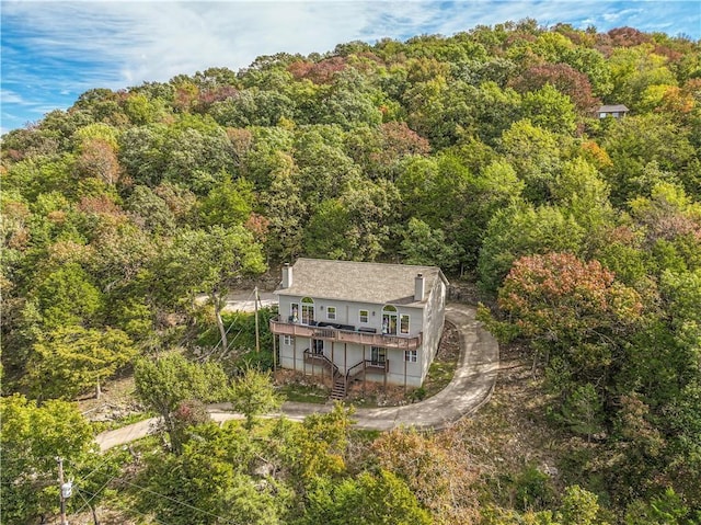 birds eye view of property featuring a wooded view