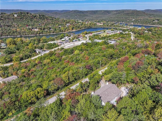 aerial view featuring a forest view and a water view