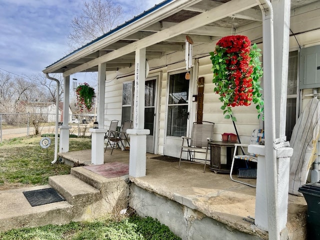 view of patio / terrace featuring covered porch and fence