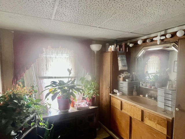 bathroom with vanity and a paneled ceiling