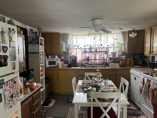 kitchen with ceiling fan, white appliances, and a sink