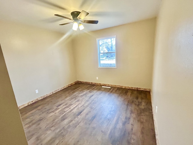 spare room with ceiling fan, wood finished floors, and baseboards