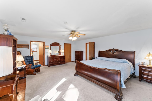 bedroom with visible vents, a ceiling fan, and carpet flooring