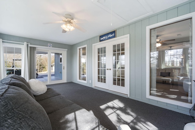 sunroom / solarium featuring a ceiling fan and french doors