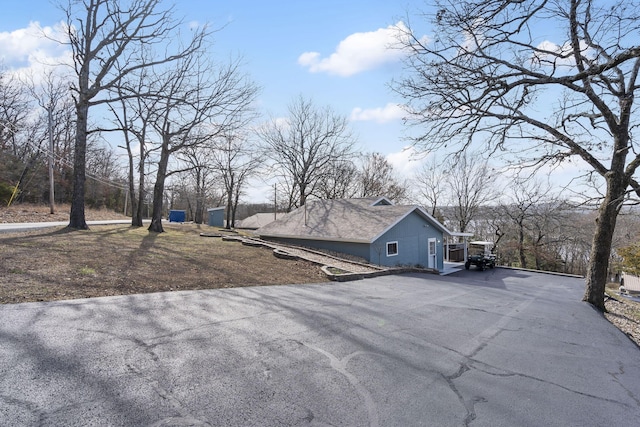 view of side of home with driveway