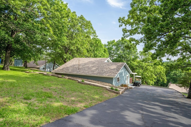 466 Buck Run Dr, Branson West, MO 65737 - view of side of home featuring a yard, asphalt driveway, and a shingled roof