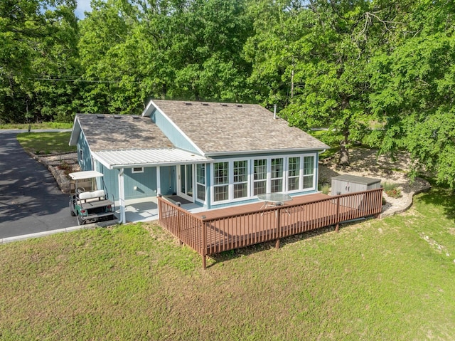466 Buck Run Dr, Branson West, MO 65737 - rear view of property with a sunroom, a deck, roof with shingles, and a lawn