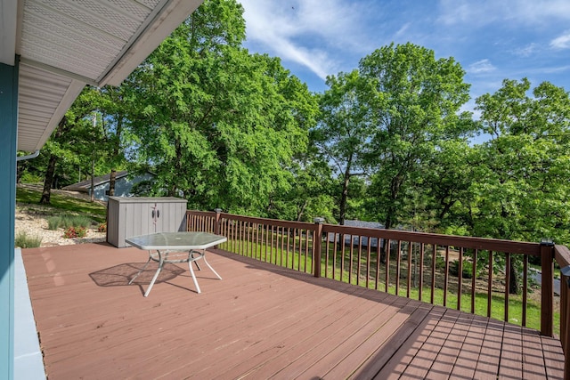 466 Buck Run Dr, Branson West, MO 65737 - deck with a storage shed, an outbuilding, outdoor dining space, and view of wooded area