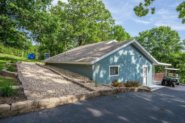 466 Buck Run Dr, Branson West, MO 65737 - view of side of home featuring a shingled roof and brick siding