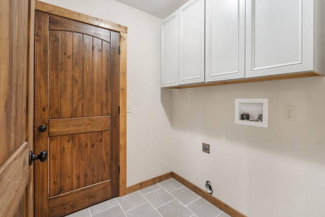 washroom with cabinet space, light tile patterned floors, baseboards, washer hookup, and electric dryer hookup