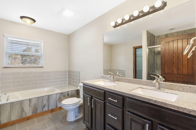 full bathroom featuring double vanity, a sink, a bath, and tile patterned floors