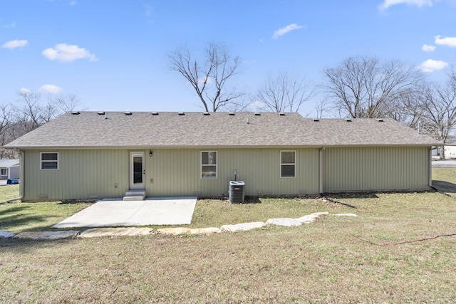 rear view of property with a shingled roof, a lawn, a patio, crawl space, and central air condition unit