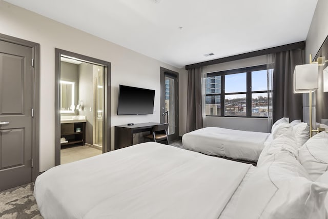 bedroom with connected bathroom and visible vents