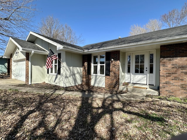 exterior space with a garage, concrete driveway, and brick siding