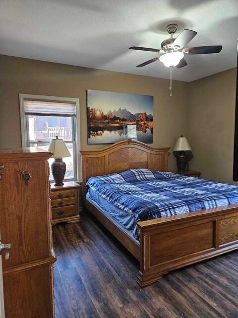 bedroom featuring a ceiling fan and dark wood-type flooring