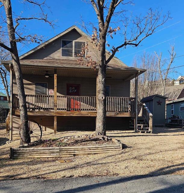 bungalow-style home with covered porch and a shingled roof