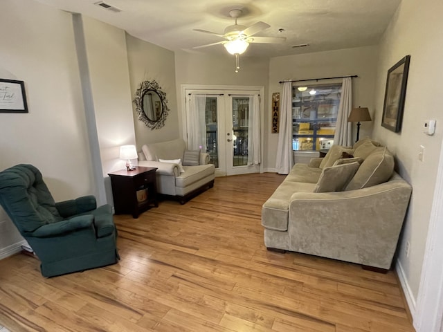 sitting room with visible vents, baseboards, a ceiling fan, french doors, and light wood-type flooring