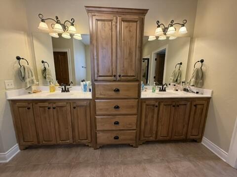 bathroom with vanity and baseboards