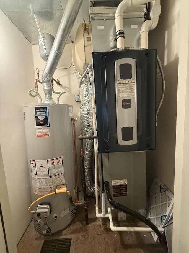 utility room featuring water heater