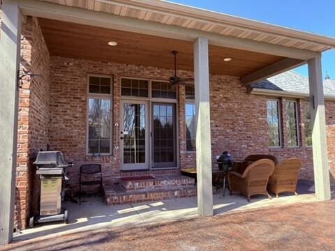 exterior space featuring a patio and brick siding