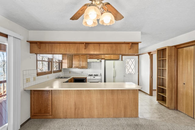 kitchen with white appliances, open shelves, and brown cabinetry