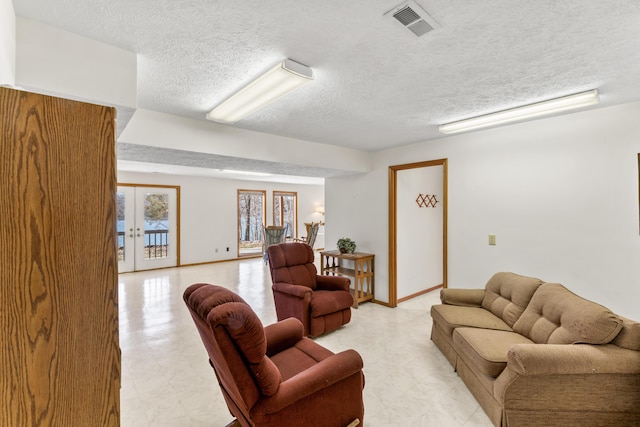 living area with light floors, visible vents, a textured ceiling, and french doors