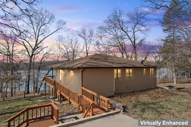 24311 Raintree Ln, Shell Knob, MO 65747 - property exterior at dusk with stairs and roof with shingles