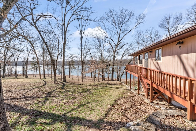 view of yard featuring a deck with water view