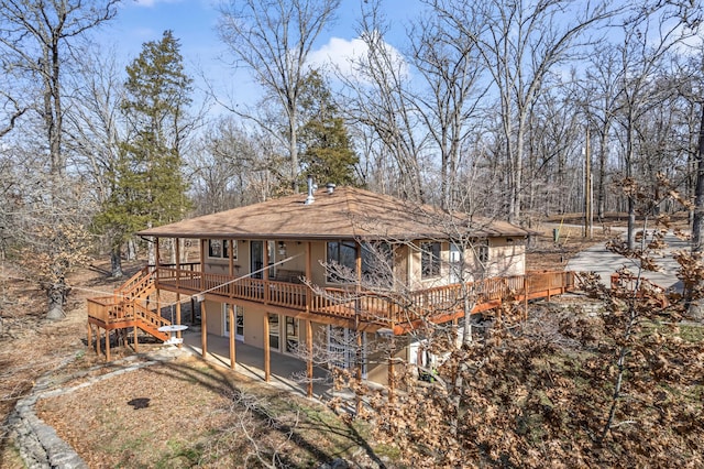 back of property featuring a patio, a deck, and stairs