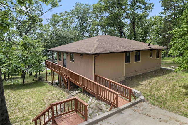 24311 Raintree Ln, Shell Knob, MO 65747 - view of side of home featuring roof with shingles, a yard, stairway, and a deck
